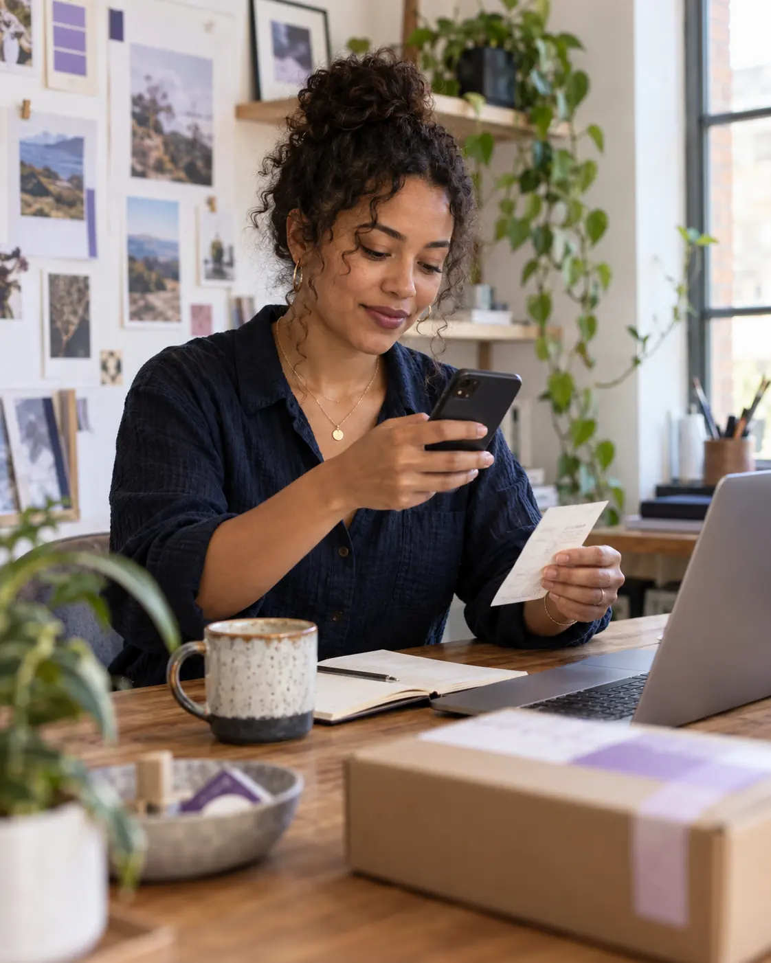 Self-employed professional capturing a receipt at a studio desk